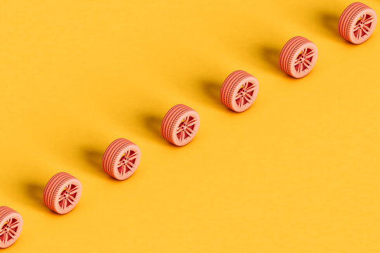 a row of pink car wheels