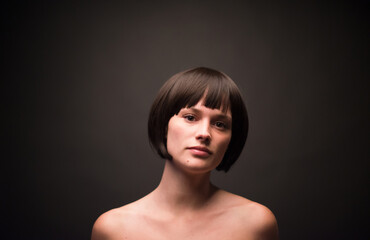 Confident woman with stylish haircut at studio