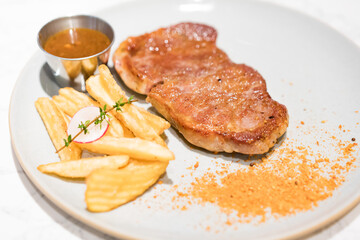 A steak and French fries on the plate