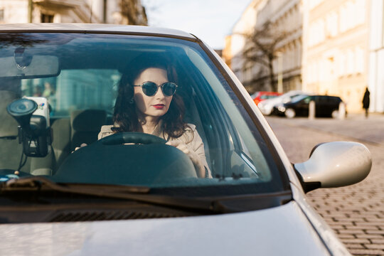 Classically beautiful woman in her car