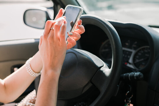 Close up of a woman using a phone in the car
