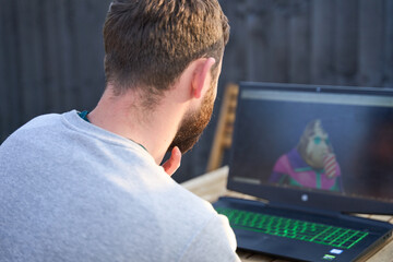 Man looking at laptop screen displaying his NFT purchase