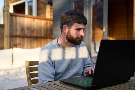 Man sitting outside with laptop
