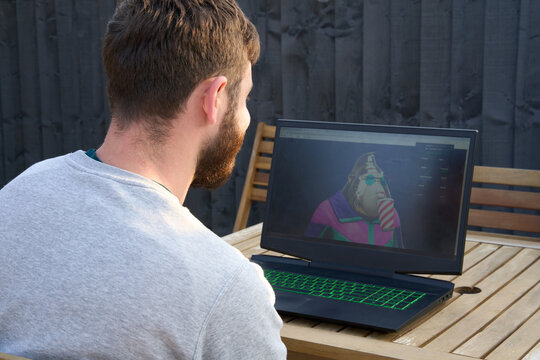 Man looking at his NFT purchase on laptop screen