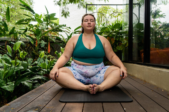 Plus size Gen Z woman doing yoga