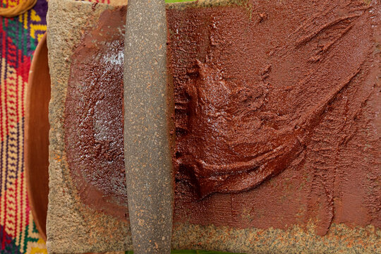 Closeup to the texture of cacao ground in metate to make chocolate