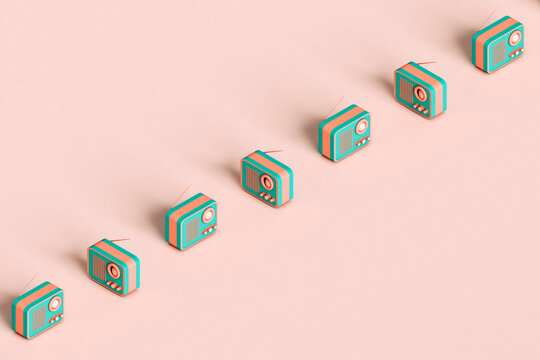 a row of vintge radios on a pink background with copy space