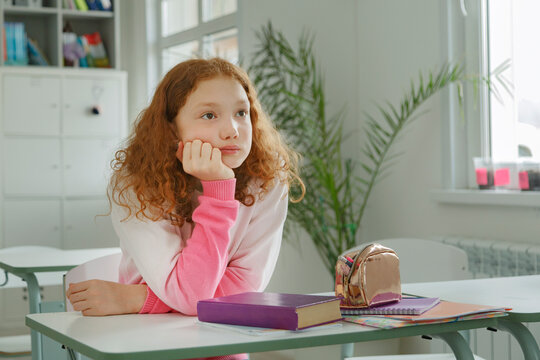 Redhead student sitting at desk