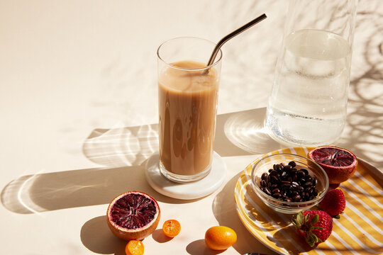 Glass of iced latte with a straw