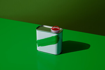 green brushstroke in a white motor oil can