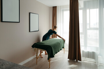 Osteopath or masseuse prepares cabinet for procedure.