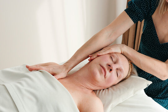 Senior woman having cosmetology massage at spa.