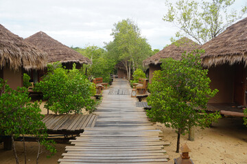 Fototapeta na wymiar A wooden walkway leading to the villa in the resort.