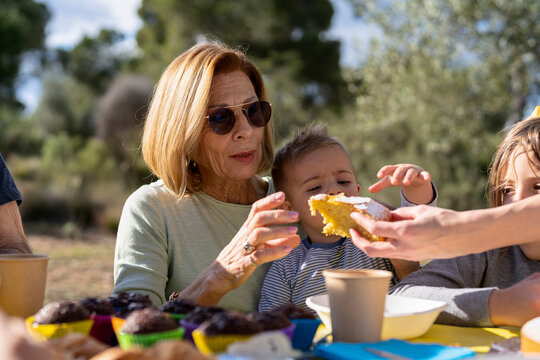 Grandma and grandson taking cake