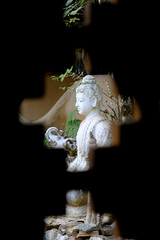 White Buddha after window in  Wat Pha Lat Monk's Trail at Thailand