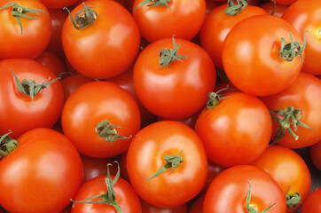 Many ripe tomatoes close up. Tomato background.