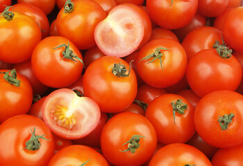 Many ripe tomatoes close up. Tomato background.