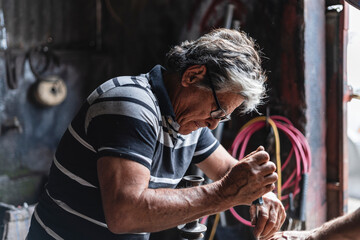Older man repairing a machine
