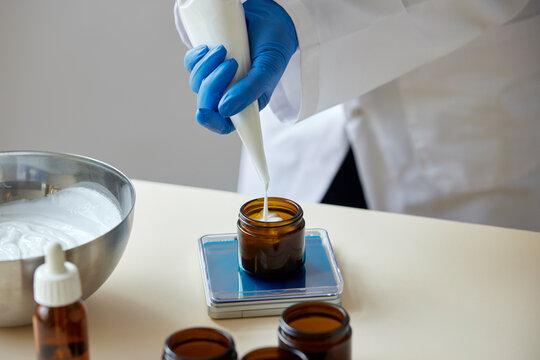 Unrecognizable pharmacist pouring skincare product