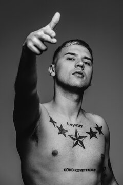 Portrait of shirtless man looking at camera