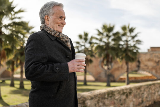 portrait of older man in a park with palm trees