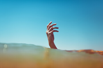Surreal hand emerging from the ocean