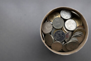 Thai baht coins in paper bucket for change in small business. spot focus