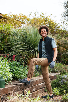 Cheerful black man working in garden