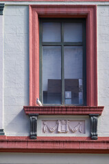 Pale Pink Facade around a Baroque Era Window on a White Building.