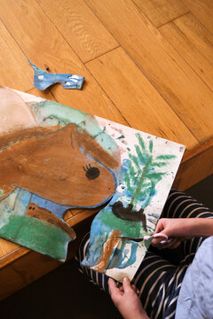 Asian little girl making art at home
