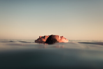 Dreamy couple portrait floating together on the sea