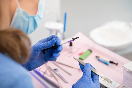 Anonymous Dentist Holding Tools
