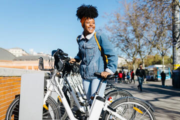 Smiling woman in bicycle park in city
