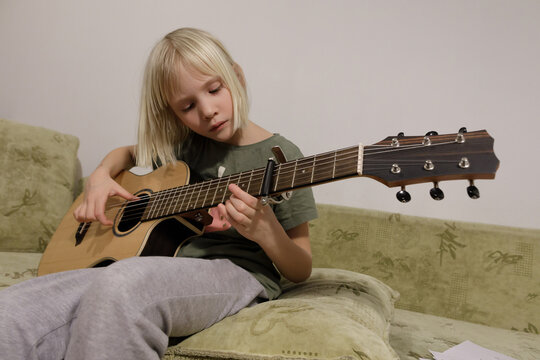 Child practicing  guitar