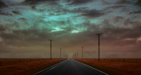 Car driving on dreamy road at cinematic misty scenery