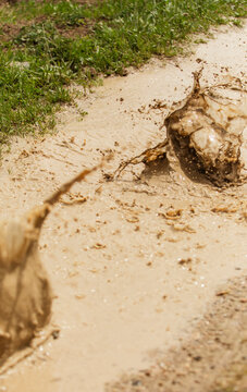 runner splashes on muddy track