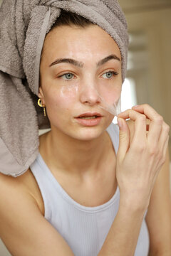 young woman with peel-off face mask