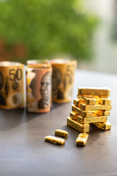 Gold bullion bars and fiat currency