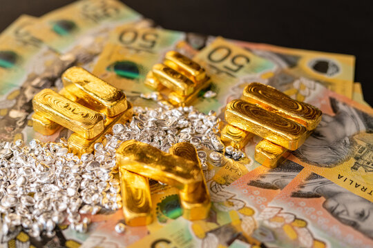 Gold bullion bars and Silver ingots on fiat currency