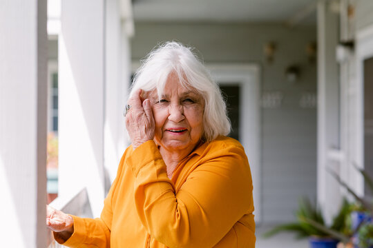 White hair senior woman squishing eyes residence portrait