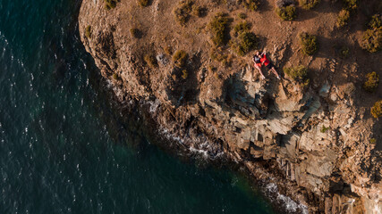 young man and woman lay on the edge of a seacoast