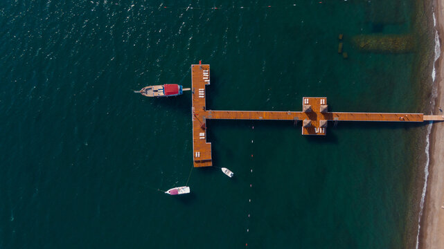 drone view of a long pier with some boats