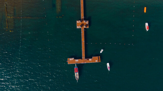 aerial view of a long pier with some boats