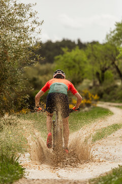 cyclist crossing a puddle of water