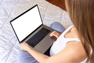Fototapeta premium Pregnancy mockup display. Pregnant woman holding blank laptop screen. Mobile pregnancy online maternity notebook mock up. Concept maternity, pregnancy, childbirth.