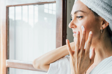 Woman Applying  cream On Face