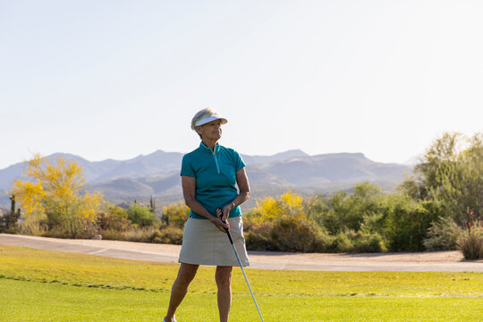 Confident and happy smiling  Senior Citizen woman Playing golf 