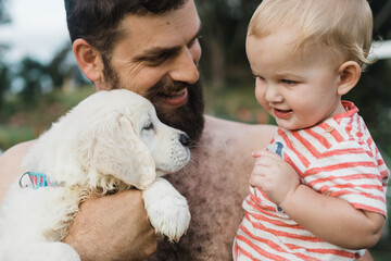 Father introducing son to puppy