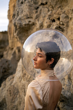 Portrait Of A Woman With Dress And Transparent Helmet In The Desert.