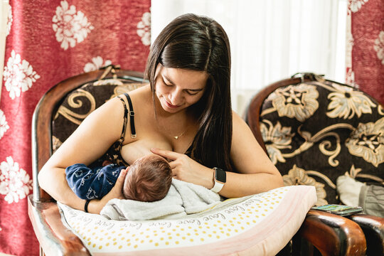 woman breastfeeding her newborn baby